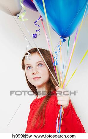 Stock Photo - Girl holding balloons. Fotosearch