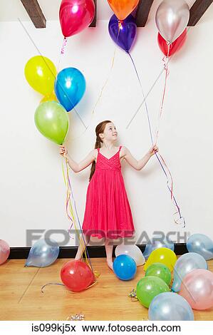 Girl holding balloons View Large Photo Image Stock Photo - Girl holding balloons. Fotosearch