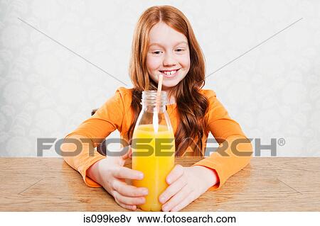 Girl with bottle of orange juice View Large Photo Image Stock Photo - Girl with bottle of orange juice. Fotosearch