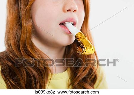 Girl with party horn blower in mouth View Large Photo Image Stock Photo - Girl with party horn blower in mouth. Fotosearch