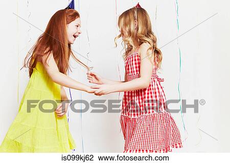 Stock Image - Girls dancing at party. Fotosearch