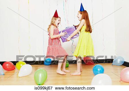 Girls fighting over birthday gift View Large Photo Image Stock Photo - Girls fighting over birthday gift. Fotosearch