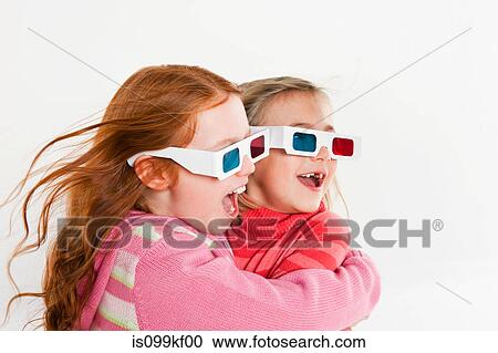 Stock Image - Girls wearing 3D glasses. Fotosearch