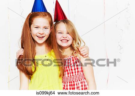 Happy girls in party hats View Large Photo Image Picture - Happy girls in party hats. Fotosearch