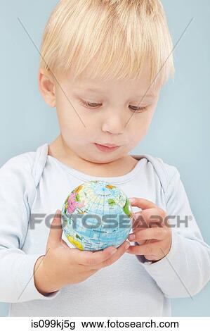 Little boy looking at little globe View Large Photo Image Stock Image - Little boy looking at little globe. Fotosearch