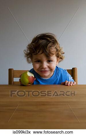 Little boy with an apple View Large Photo Image Stock Photo - Little boy with an apple. Fotosearch