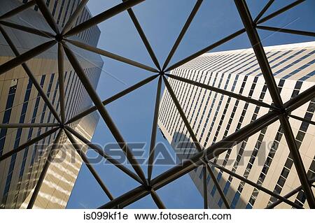 Stock Image - Looking up through steel structure to skyscrapers. Fotosearch