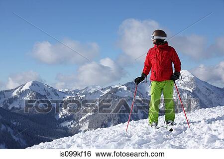 Skier taking in mountain scenery View Large Photo Image Stock Photograph - Skier taking in mountain scenery. Fotosearch