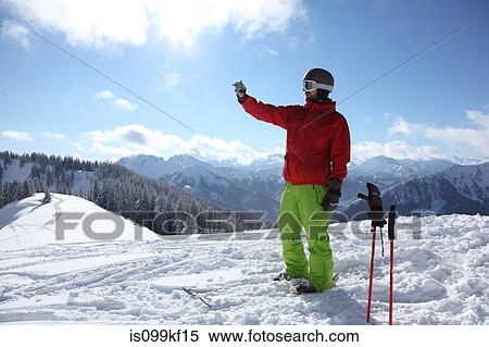 Skier taking photograph of scenery View Large Photo Image Stock Photography - Skier taking photograph of scenery. Fotosearch