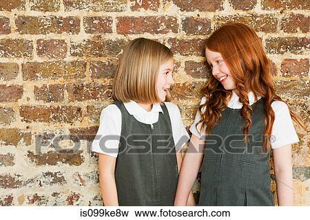Stock Photo - Two schoolgirls smiling. Fotosearch