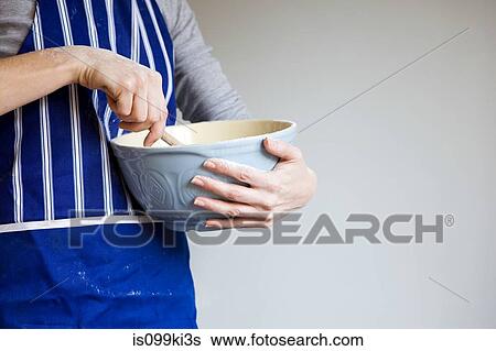 Stock Photograph - Woman with mixing bowl. Fotosearch