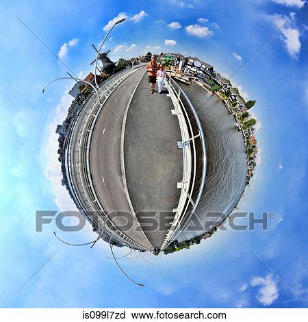 Stock Image - A couple in Zaanse Schans, Netherlands, little planet effect. Fotosearch