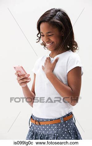 African American girl laughing and holding cellphone, studio shot View Large Photo Image Stock Image - African American girl laughing and holding cellphone, studio shot. Fotosearch