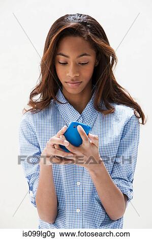 African American teenage girl using cellphone, studio shot View Large Photo Image Stock Image - African American teenage girl using cellphone, studio shot. Fotosearch