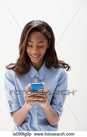 African American teenage girl using cellphone, studio shot View Large Photo Image Stock Photography - African American teenage girl using cellphone, studio shot. Fotosearch