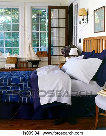 Bed with blue blanket in bedroom View Large Photo Image Stock Image - Bed with blue blanket in bedroom. Fotosearch