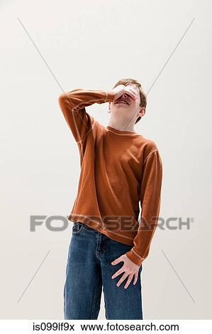 Boy in brown sweater covering eyes, studio shot View Large Photo Image Stock Photo - Boy in brown sweater covering eyes, studio shot. Fotosearch