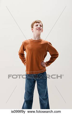 Boy in brown sweater in superhero stance, studio shot View Large Photo Image Stock Photo - Boy in brown sweater in superhero stance, studio shot. Fotosearch