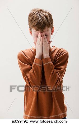 Boy in brown sweater rubbing eyes, studio shot View Large Photo Image Stock Photo - Boy in brown sweater rubbing eyes, studio shot. Fotosearch