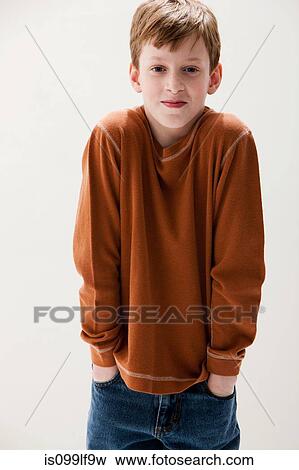 Boy in brown sweater with hands in pockets, studio shot View Large Photo Image Stock Photo - Boy in brown sweater with hands in pockets, studio shot. Fotosearch
