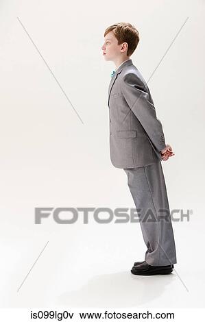 Stock Photo - Boy wearing grey suit, studio shot. Fotosearch