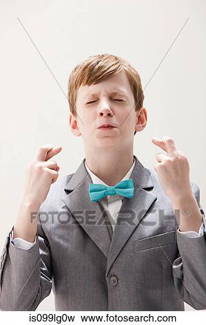 Boy wearing grey suit with fingers crossed, studio shot View Large Photo Image Stock Photo - Boy wearing grey suit with fingers crossed, studio shot. Fotosearch