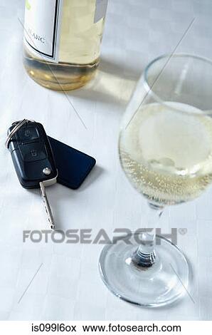Stock Photo - Car keys and a glass of white wine. Fotosearch