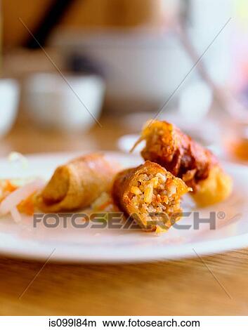 Picture - Egg roll on plate, close up. Fotosearch