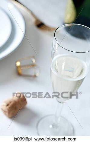 Glass of champagne on table View Large Photo Image Stock Image - Glass of champagne on table. Fotosearch
