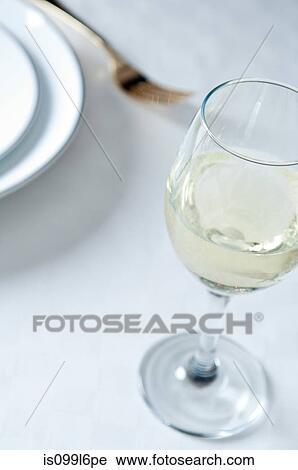 Glass of white wine on table View Large Photo Image Stock Image - Glass of white wine on table. Fotosearch