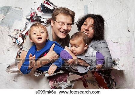 Happy family busting through a wall View Large Photo Image Stock Photograph - Happy family busting through a wall. Fotosearch