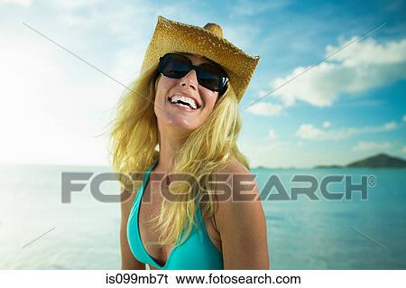 Happy woman in sunglasses and cowboy hat by the ocean View Large Photo Image Stock Photograph - Happy woman in sunglasses and cowboy hat by the ocean. Fotosearch