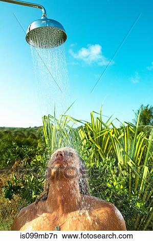 Man enjoying cool shower outdoors View Large Photo Image Picture - Man enjoying cool shower outdoors. Fotosearch