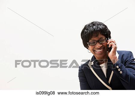 Mature African American businesswoman using cellphone, studio shot View Large Photo Image Stock Photo - Mature African American businesswoman using cellphone, studio shot. Fotosearch