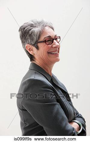 Mature businesswoman smiling, studio shot View Large Photo Image Stock Photograph - Mature businesswoman smiling, studio shot. Fotosearch