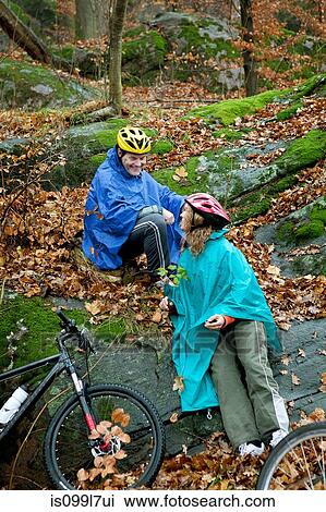 Mature couple in forest with bicycles View Large Photo Image Stock Image - Mature couple in forest with bicycles. Fotosearch