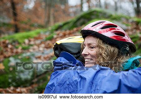 Mature couple wearing cycling helmets and embracing View Large Photo Image Stock Image - Mature couple wearing cycling helmets and embracing. Fotosearch