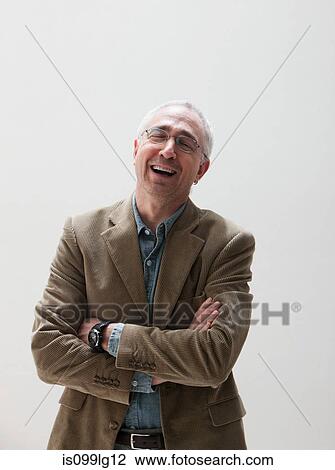 Mature man laughing, studio shot View Large Photo Image Stock Image - Mature man laughing, studio shot. Fotosearch