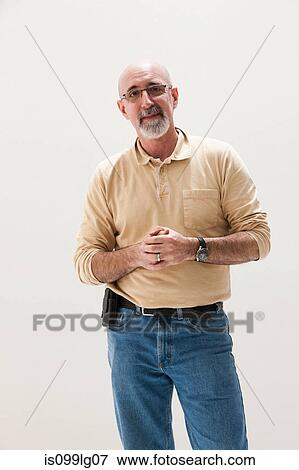Mature man with hands clasped, studio shot View Large Photo Image Stock Photo - Mature man with hands clasped, studio shot. Fotosearch