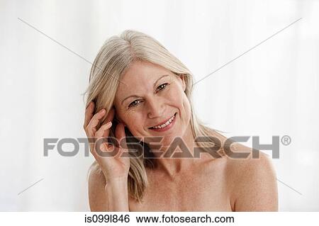 Mature woman holding touching hair, portrait View Large Photo Image Stock Photograph - Mature woman holding touching hair, portrait. Fotosearch