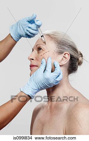 Mature woman receiving injections View Large Photo Image Picture - Mature woman receiving injections. Fotosearch