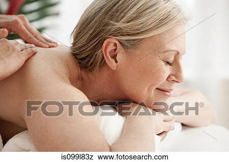 Stock Photo - Mature woman receiving massage. Fotosearch