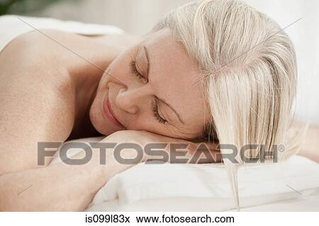 Stock Photo - Mature woman relaxing on massage table. Fotosearch