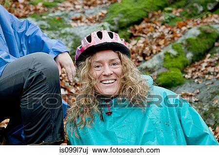 Mature woman resting from cycle ride in forest View Large Photo Image Stock Image - Mature woman resting from cycle ride in forest. Fotosearch