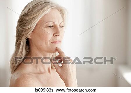 Mature woman touching chin View Large Photo Image Stock Photograph - Mature woman touching chin. Fotosearch