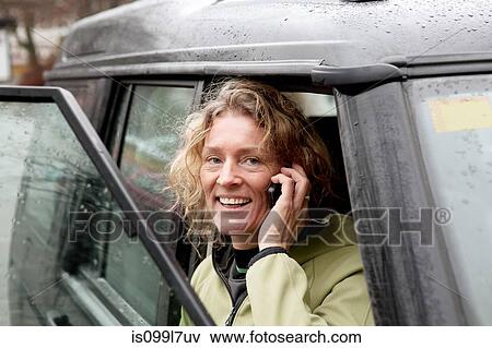 Mature woman using cellphone in car View Large Photo Image Stock Photo - Mature woman using cellphone in car. Fotosearch