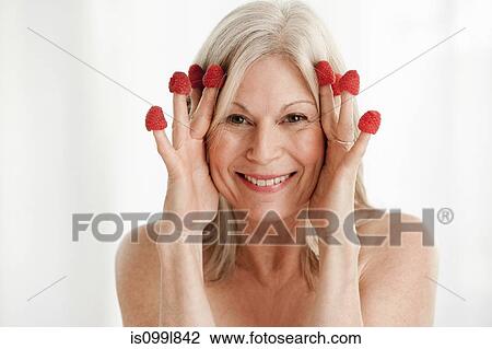Mature woman wearing raspberries on fingers View Large Photo Image Stock Image - Mature woman wearing raspberries on fingers. Fotosearch