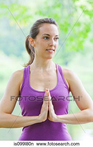 Mid adult woman performing yoga prayer pose by river View Large Photo Image Picture - Mid adult woman performing yoga prayer pose by river. Fotosearch