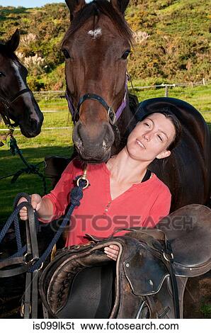 Mid adult woman with horses View Large Photo Image Stock Photograph - Mid adult woman with horses. Fotosearch