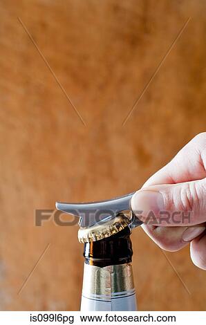 Opening a bottle of beer View Large Photo Image Stock Image - Opening a bottle of beer. Fotosearch